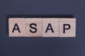 ASAP as soon as possible from wooden letters on a gray background