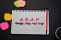 ASAP - Always Stop And Pray write on a book on office desk. Christian faith concept