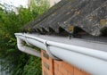 Asbestos house roof with rain gutter pipeline