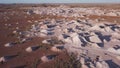 ascending aerial shot of opal mine mullock heaps at coober pedy