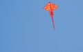 Colorful kite soars upward blue sky