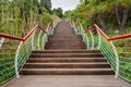 Ascending hillside planked stairway in cloudy summer