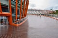 Ascending spiral planked walkway of modern viewing deck in cloudy summer after rain