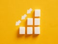 Ascending sugar cube graph with descending arrows indicating to reduce sugar intake and healthy nutrition Royalty Free Stock Photo