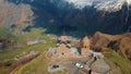 ascending view of ancient Gergeti Holy Trinity Church in Kazbegi, Georgia Royalty Free Stock Photo