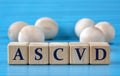 ASCVD - acronym on wooden cubes on a blue background with wooden round balls