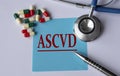 ASCVD - medical abbreviation on a blue sheet on the background of tablets, stethoscope and pen