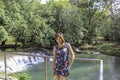 Asean woman and water in the stream is green and bright green tree at Kapo Waterfall Fores Park , Chumphon in Thailand Royalty Free Stock Photo
