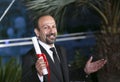 Asghar Farhadi poses with his award for the Best Screenplay Royalty Free Stock Photo