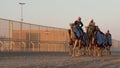 Ash-Shahaniyah, Qatar- March 21 2021 : Jockeys taking the camels for walk in the camel race tracks Royalty Free Stock Photo