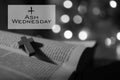 Ash Wednesday. Happy Ash Wednesday concept with wooden holy cross crucifix of Jesus Christ on open bible book page in black white. Royalty Free Stock Photo