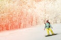 ASHA, RUSSIA - 27 april 2011: a girl in a bright suit, goggles and without a helmet on a snowboard is rolling down the slope, her