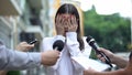 Ashamed businesswoman closing face with hands on press conference, scandal