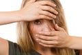 Ashamed embarrassed blonde woman with hands on face