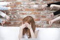 Ashamed girl surrounded by hands Royalty Free Stock Photo