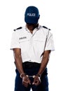 Ashamed policeman with handcuffs Royalty Free Stock Photo