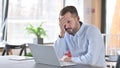 Ashamed Young Man Sitting Disappointed at Work, Loss