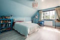Blue decorated bedroom with sloping ceiling