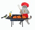 Cat ashen in red apron cooks grill sausages 2