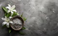 Ashes bowl and lilies flower branch on concrete stone background. cremation, funeral, burial ceremony concept