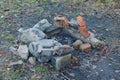 Ashes of an extinct fire with bricks and stones on the ground outdoors in nature Royalty Free Stock Photo
