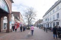 Ashford, Kent, United Kingdom - March 9, 2020: People walking and chatting on High Street in the pedestrianised town centre