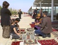 Ashgabat, Turkmenistan - Mart 15.2022: People buy a traditional Turkmen handmade rug at the Oriental bazaar Royalty Free Stock Photo