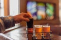 Ashland, WI/USA - 10-07-2018: Man sampling beer from flight at local brewery