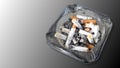 Ashtray and butted out cigarettes isolated on gradient grey bac