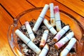 Ashtray and butted out cigarettes with lipstick Royalty Free Stock Photo