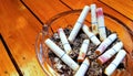 Ashtray and butted out cigarettes with lipstick Royalty Free Stock Photo