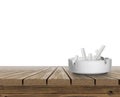 Ashtray full of cigarettes butts on wooden table top on white background Royalty Free Stock Photo