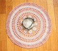 Ashtray made out of big seashell lying on home-made crocheted tablecloth. Vintage
