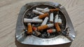 Ashtrays full of cigarette marks are not good for health.