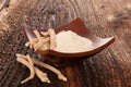 Ashwagandha powder in bowl with roots Royalty Free Stock Photo