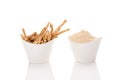 Ashwagandha powder and roots in white cups. Royalty Free Stock Photo