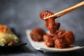 Gochujang ribs and noodles on dark cement background