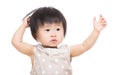 Asia baby girl hands up and touch her head Royalty Free Stock Photo
