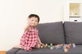 Asia baby girl play toy block and sitting on sofa Royalty Free Stock Photo