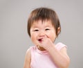 Asia baby girl put finger into mouth Royalty Free Stock Photo