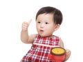 Asia baby girl with snack box and thumb up Royalty Free Stock Photo