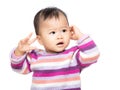 Asia baby girl touch her ear Royalty Free Stock Photo