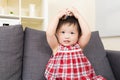 Asia baby girl touch her head Royalty Free Stock Photo