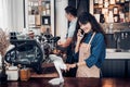 Asia Barista waiter use tablet take order from customer in coffee shop,cafe owner writing drink order at counter bar,Food and Royalty Free Stock Photo