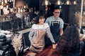 Asia barista waiter and waitress take order from customer in coffee shop,Two cafe owner writing drink order at counter