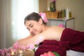 Asia beauty woman lying down on massage bed with scrub sugar and salt aroma at Thai spa and wellness center, Royalty Free Stock Photo