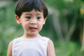 Asia boy he mouth aftertaste from eating chocolate ice cream or chocolate dessert. A sweet-toothed child eat chocolate. Kid with