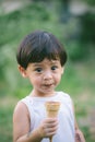 Asia boy he mouth aftertaste from eating chocolate ice cream or chocolate dessert. A sweet-toothed child eat chocolate. Kid with