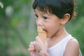 Asia boy he mouth aftertaste from eating chocolate ice cream or chocolate dessert. A sweet-toothed child eat chocolate. Kid with