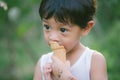 Asia boy he mouth aftertaste from eating chocolate ice cream or chocolate dessert. A sweet-toothed child eat chocolate. Kid with